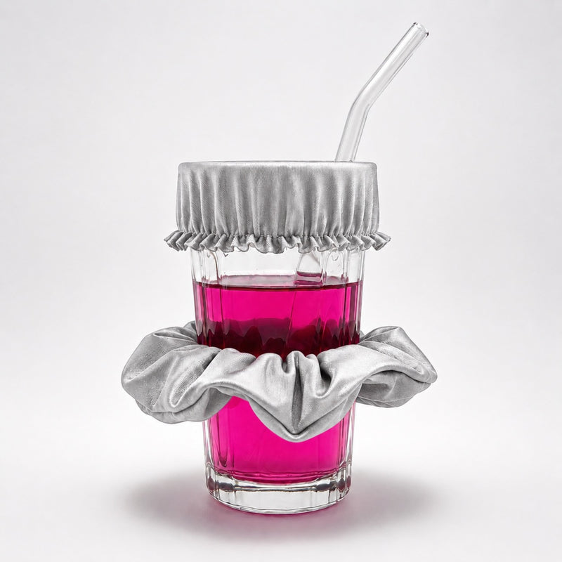 Chouchou anti-drogue argent Protect Your Glass déployé sur un verre avec paille.